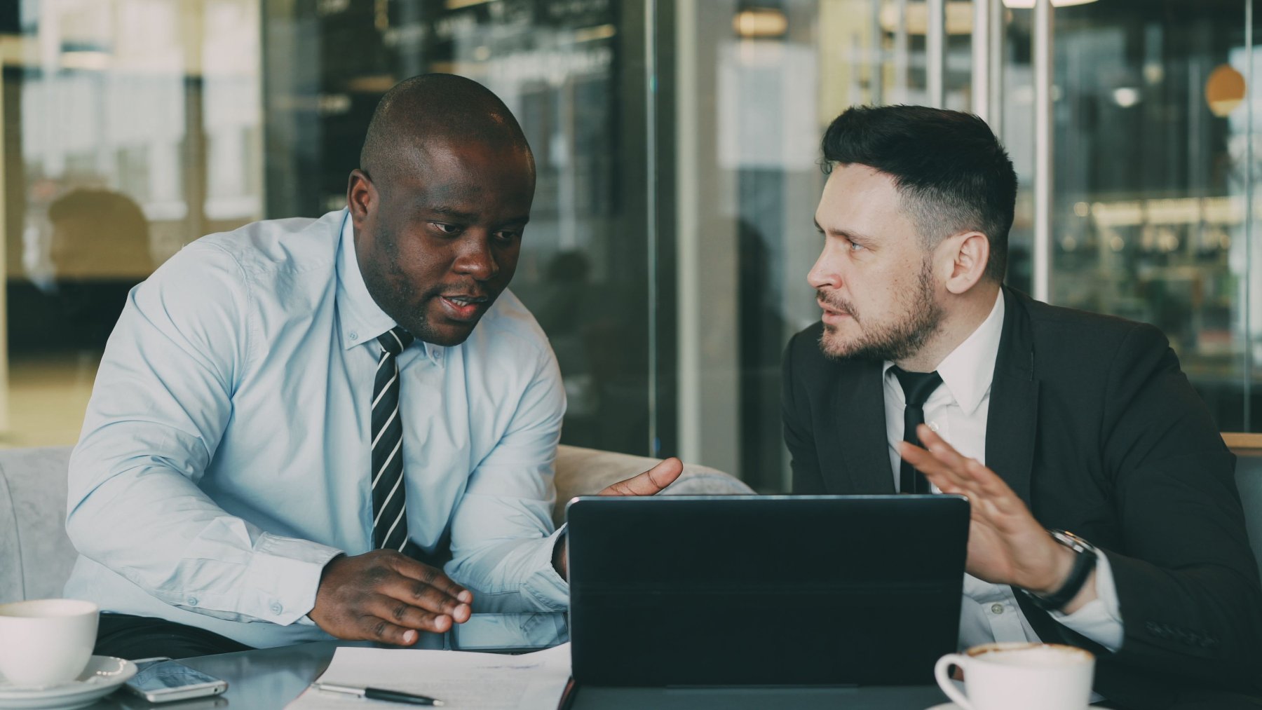 Colleagues discussing their work at a laptop