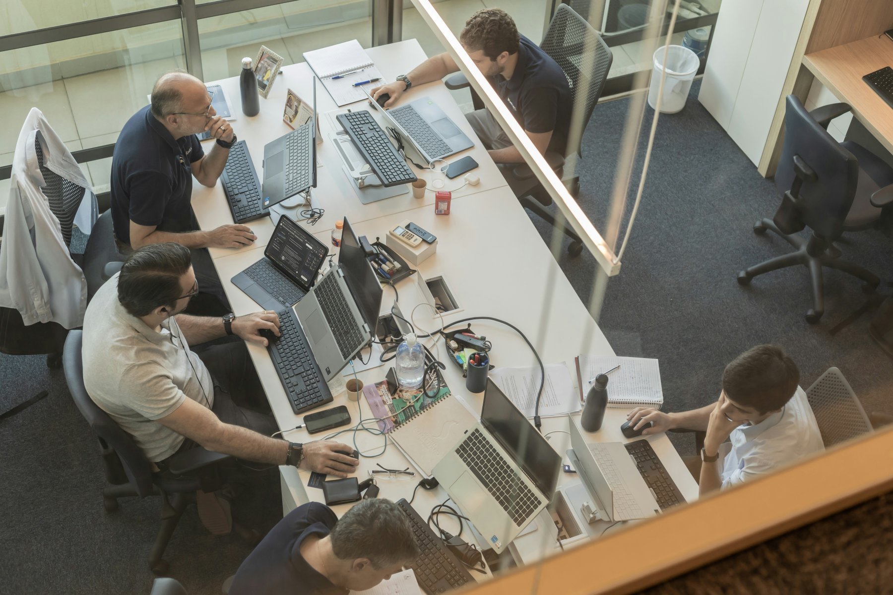 Team collaborating around desks in a bright studio